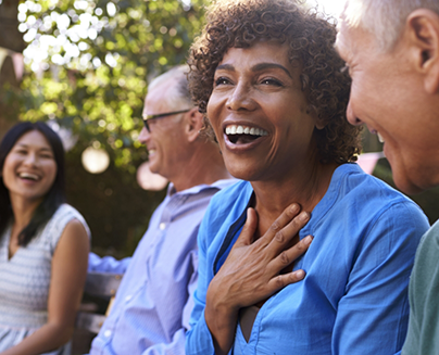 Group of older adults laughing together outdoors