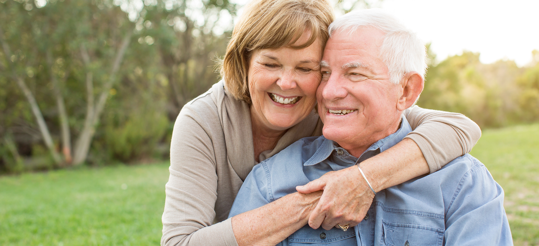 Senior couple smiling outdoors with dentures in Cleburne