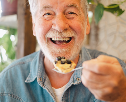 Senior man smiling during a meal