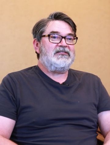 Man in black tee shirt sitting in dental office