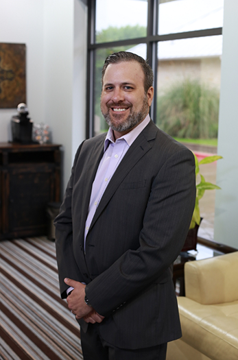 Cleburne dentist Doctor Chris Long smiling in a suit