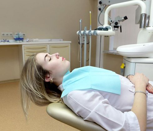 Relaxed dental patient, reclining in treatment chair