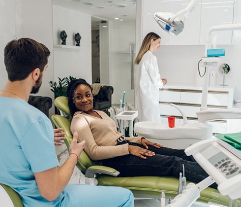 Dentist and patient discussing details of treatment plan