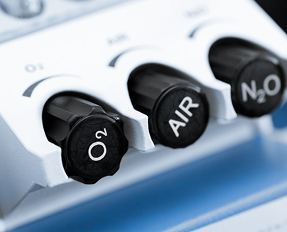 Three buttons on a machine labeled oxygen air and nitrous oxide