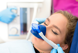 Young woman in dental chair wearing a nose mask for nitrous oxide sedation dentistry