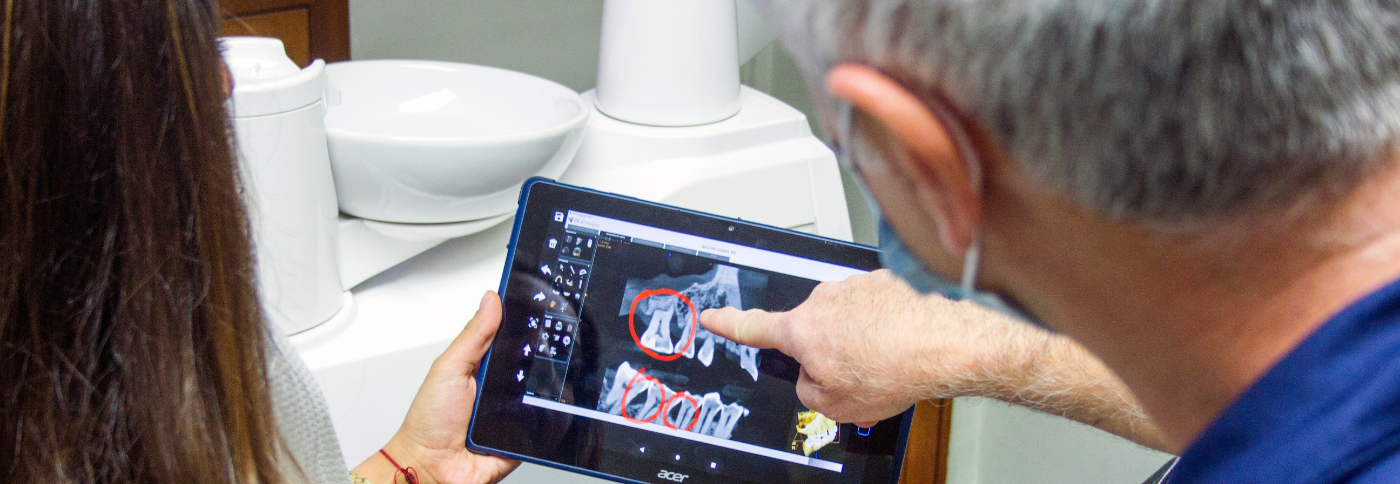 Dentist showing a patient an x ray of their teeth